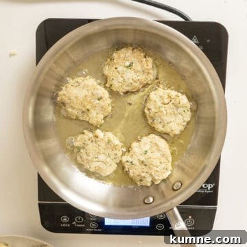 Frying cauliflower cakes in olive oil.