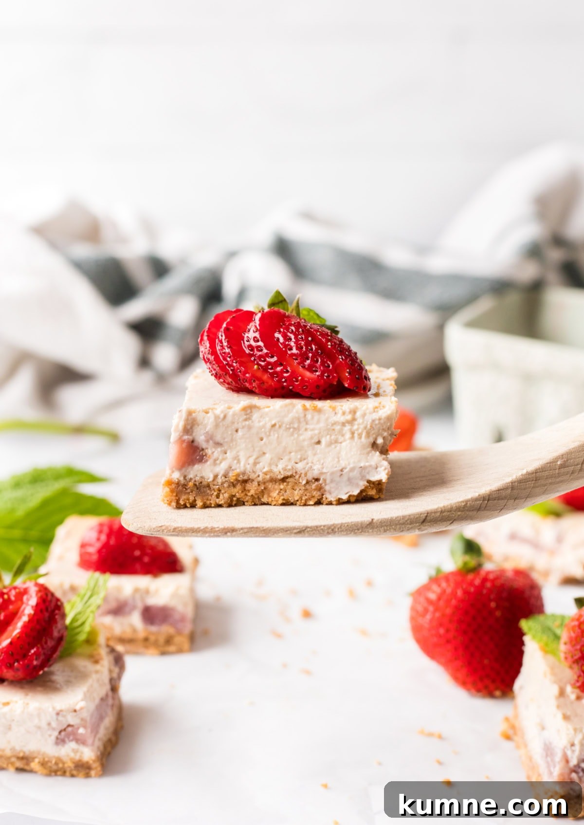 spatula holding a strawberry cheesecake bar