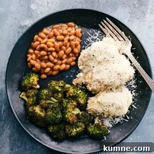 Creamy Baked Chicken Alfredo Casserole Recipe 7 Baked alfredo chicken served on a plate with beans and baked broccoli.