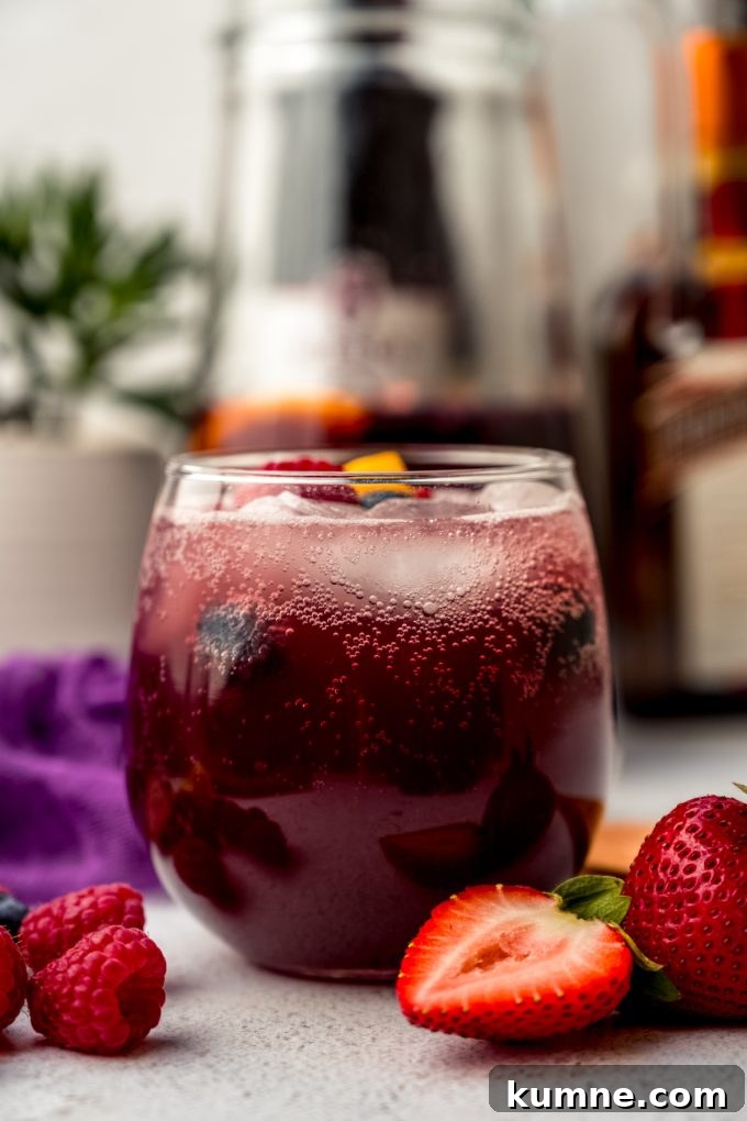 Berry Sangria and Refreshing Non-Alcoholic Berry Mocktail 15 A glass of berry sangria on a surface.