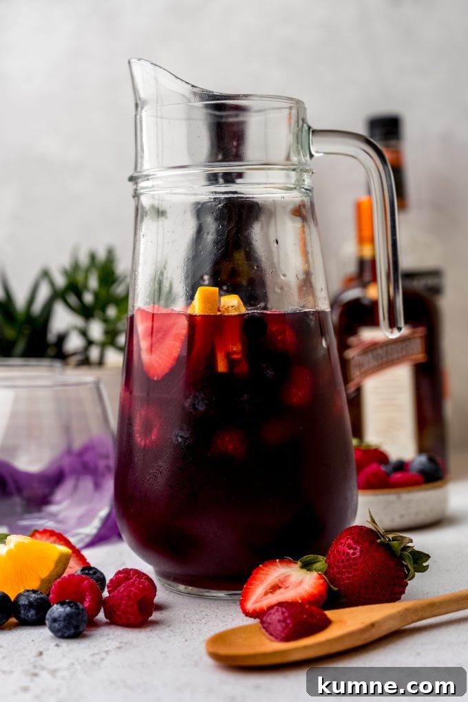 Berry Sangria and Refreshing Non-Alcoholic Berry Mocktail 17 A glass pitcher of berry sangria.