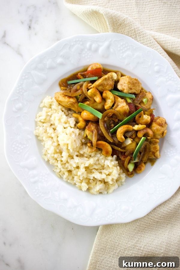 Thai cashew chicken with white rice on a white plate