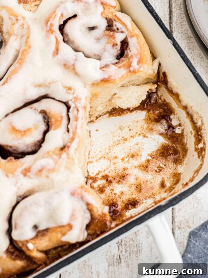 A baking dish with Amish Cinnamon Rolls with one missing. Cropped square.