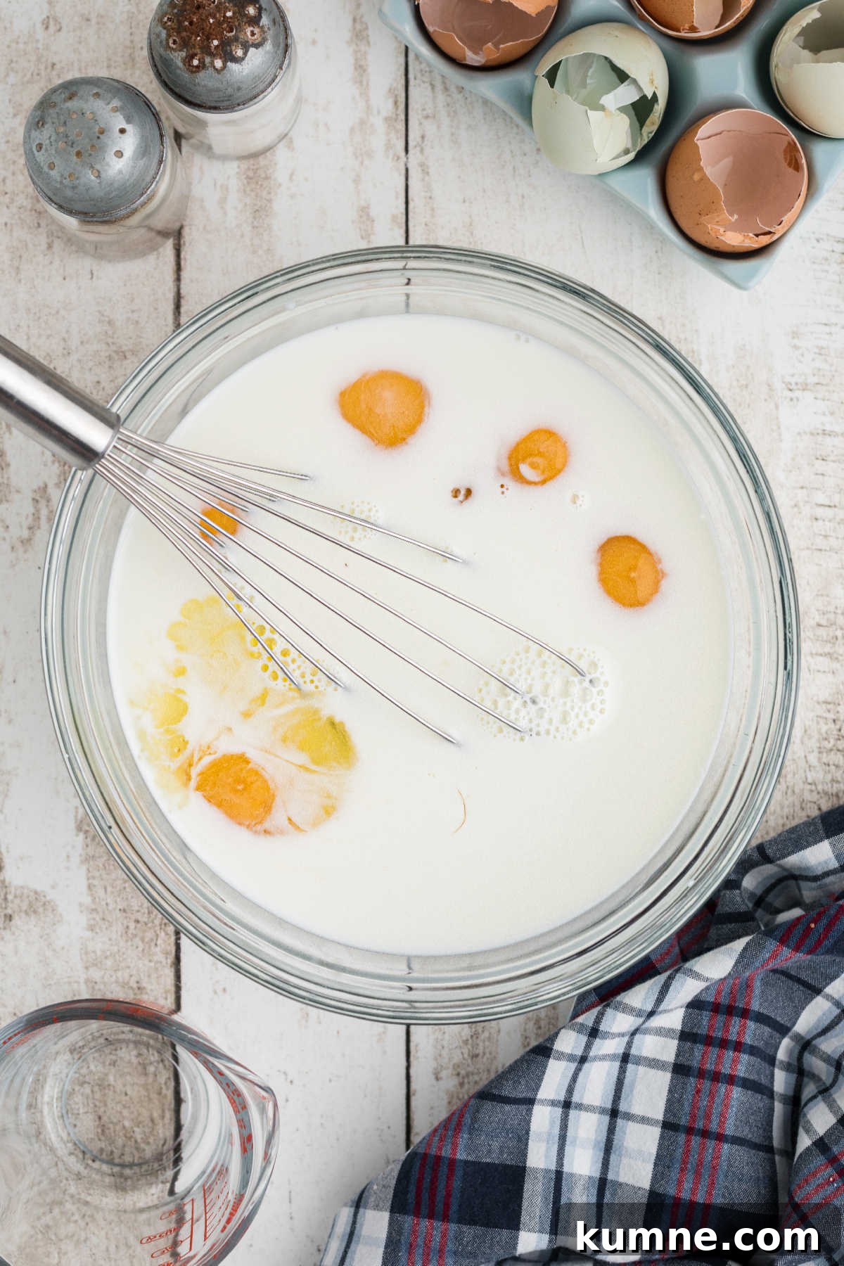 Eggs and milk being beaten together in a bowl.