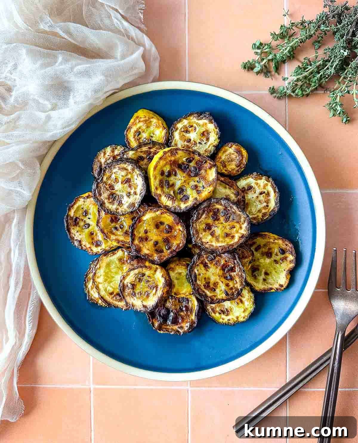 Air fryer zucchini and squash on a blue plate.