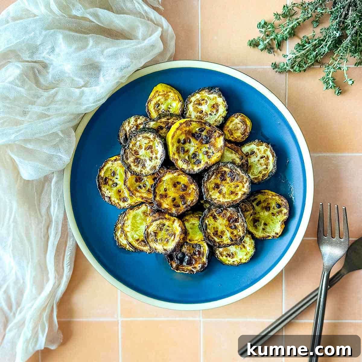 Air fryer zucchini and squash on a blue plate.