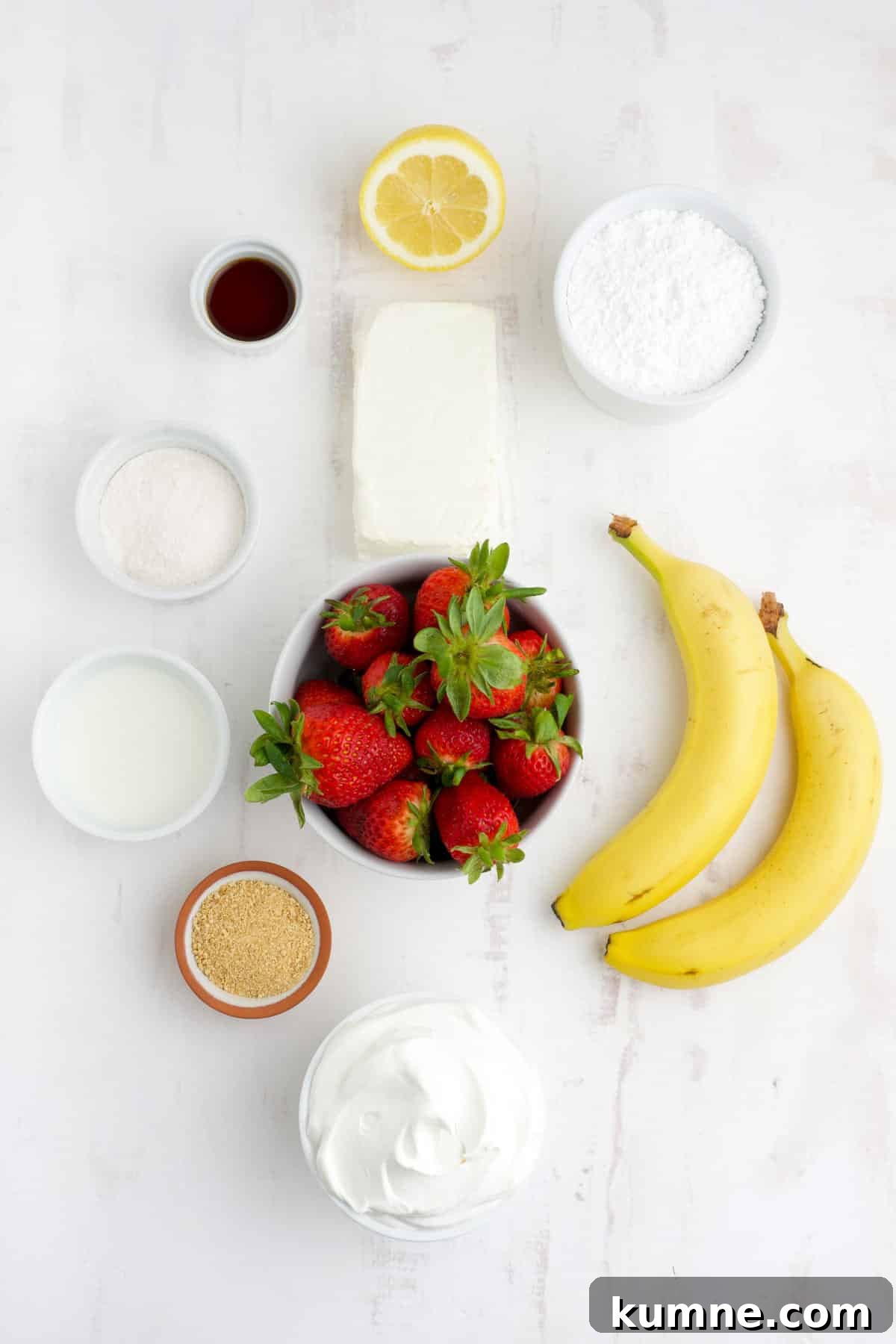 Ingredients to make strawberry banana cheesecake salad on the table.