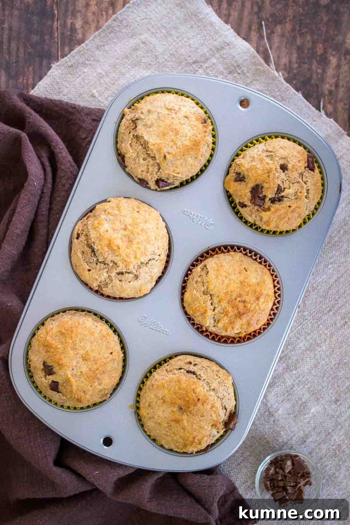 Chocolate Chip Banana Muffins in a muffin tin.