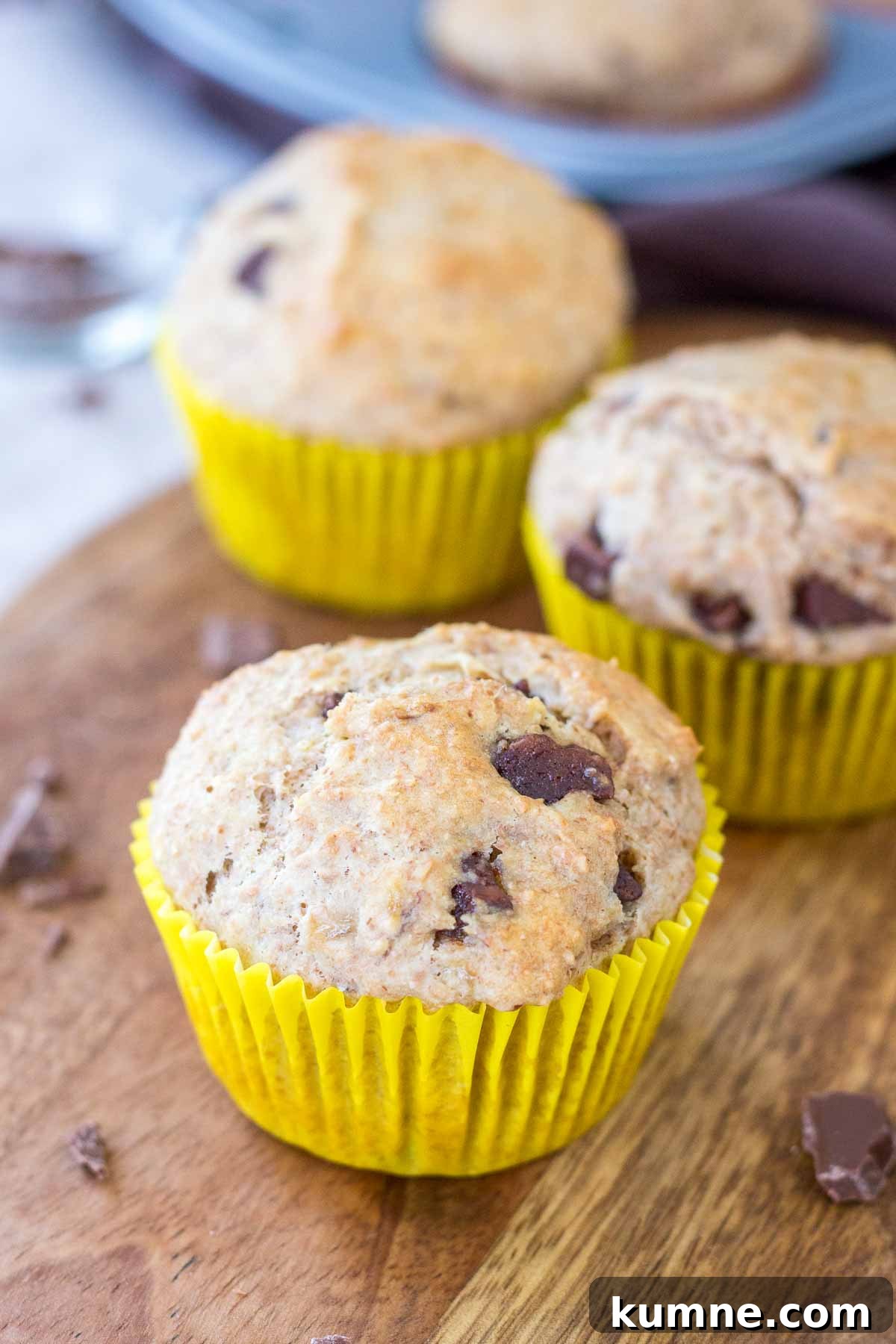 Chocolate Chip Banana Muffins served on a wooden plate.