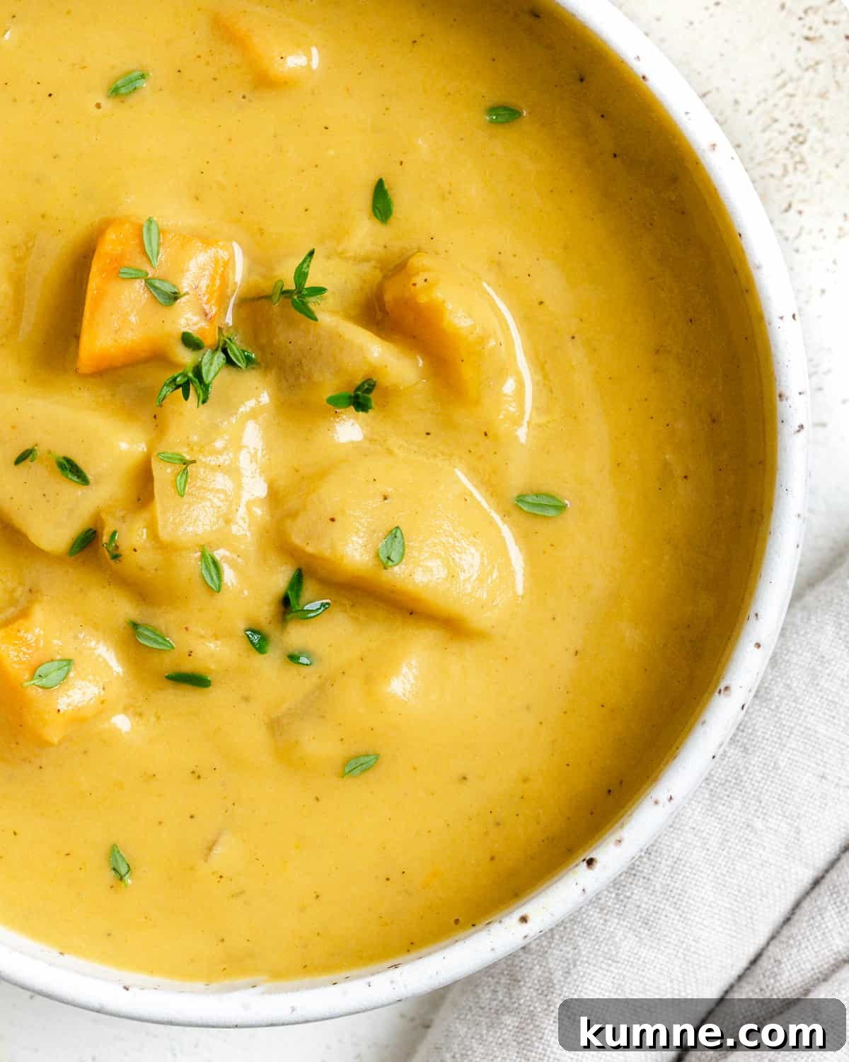 completed Roasted Delicata Squash and Sweet Potato Soup in a white bowl against a light background