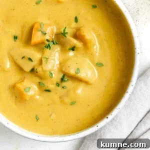 completed Roasted Delicata Squash and Sweet Potato Soup in a white bowl against a light background