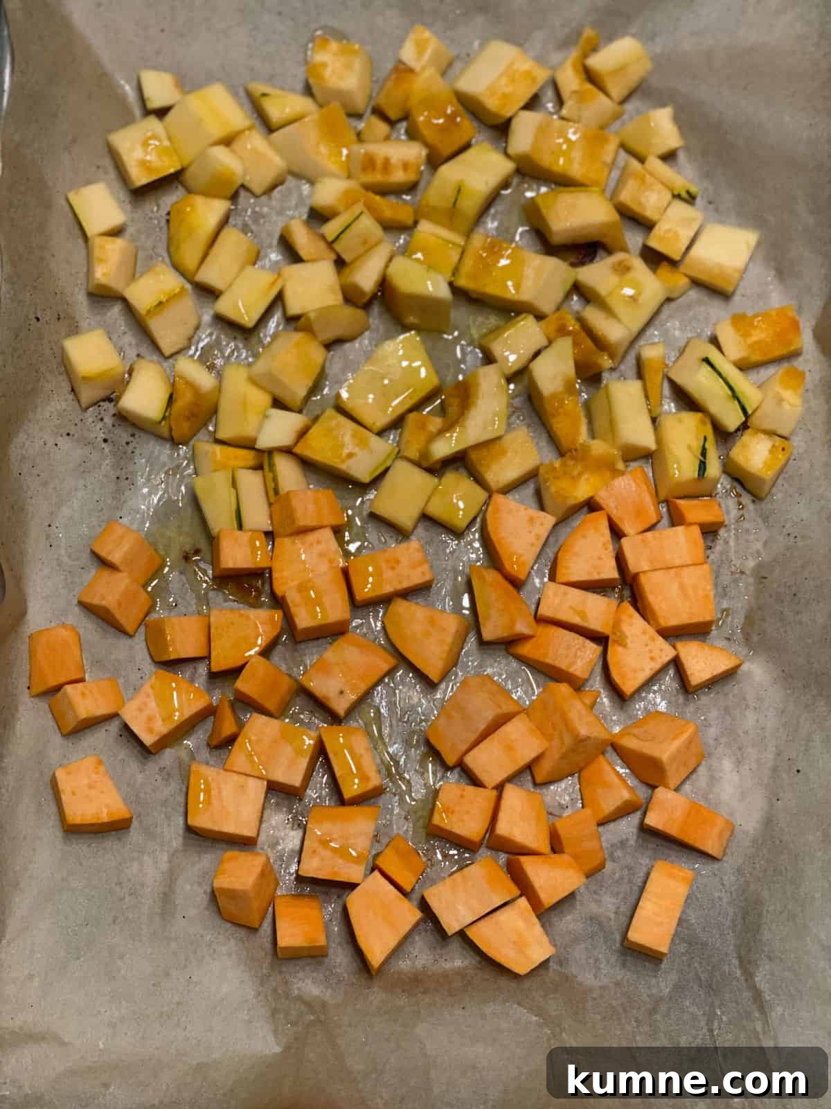 process shot of roasting squash and sweet potato in baking tray