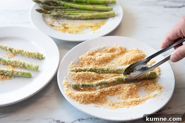 Crispy Keto Air Fryer Asparagus Recipe 6 Coating Asparagus with crushed pork rinds and parmesan