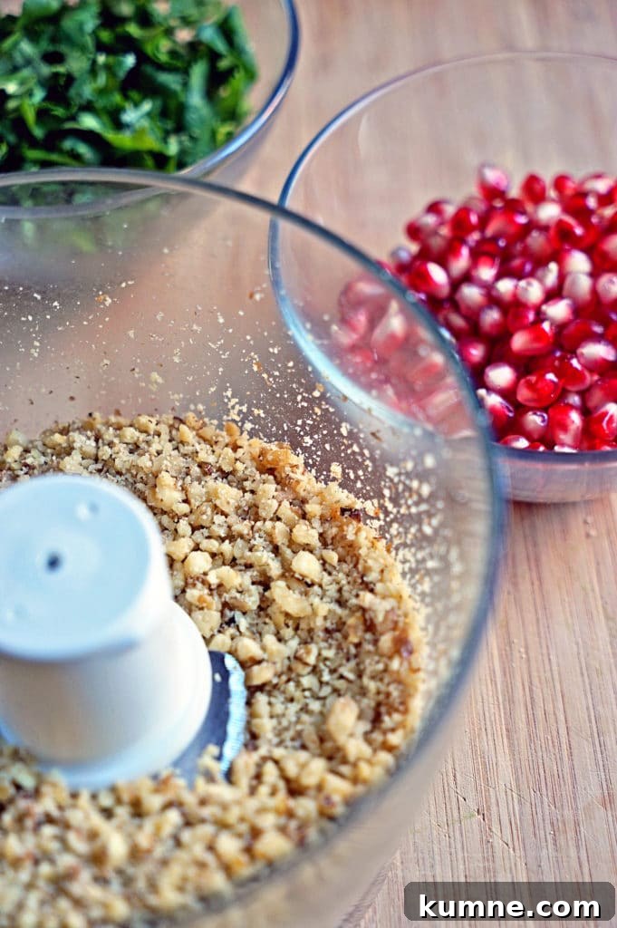 chopped nuts in bowl of food processor