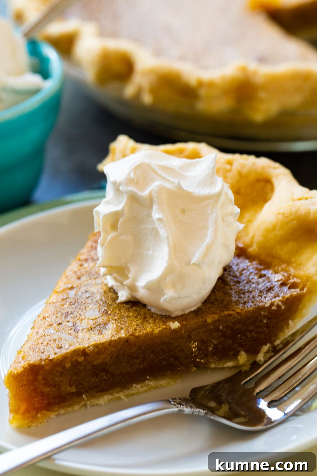 Slice of Caramel Chess Pie topped with whipped cream.