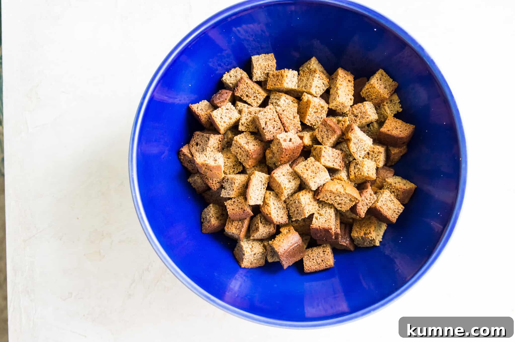 Gluten-Free Paleo Stuffing Made with Paleo Bread 3 A bowl with dried bread cubes in it.