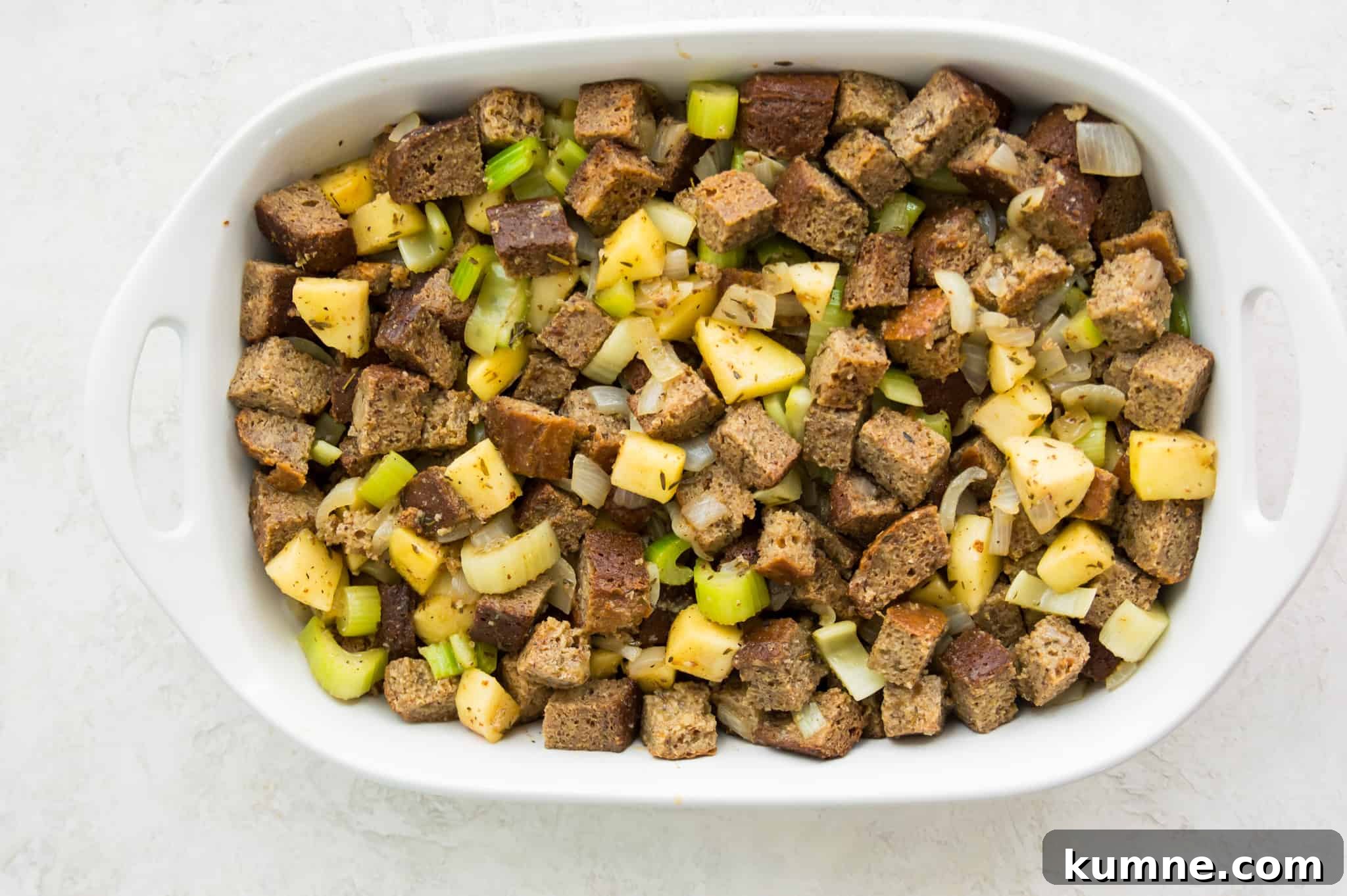 Gluten-Free Paleo Stuffing Made with Paleo Bread 8 A casserole dish with an uncooked bread stuffing mixture in it.