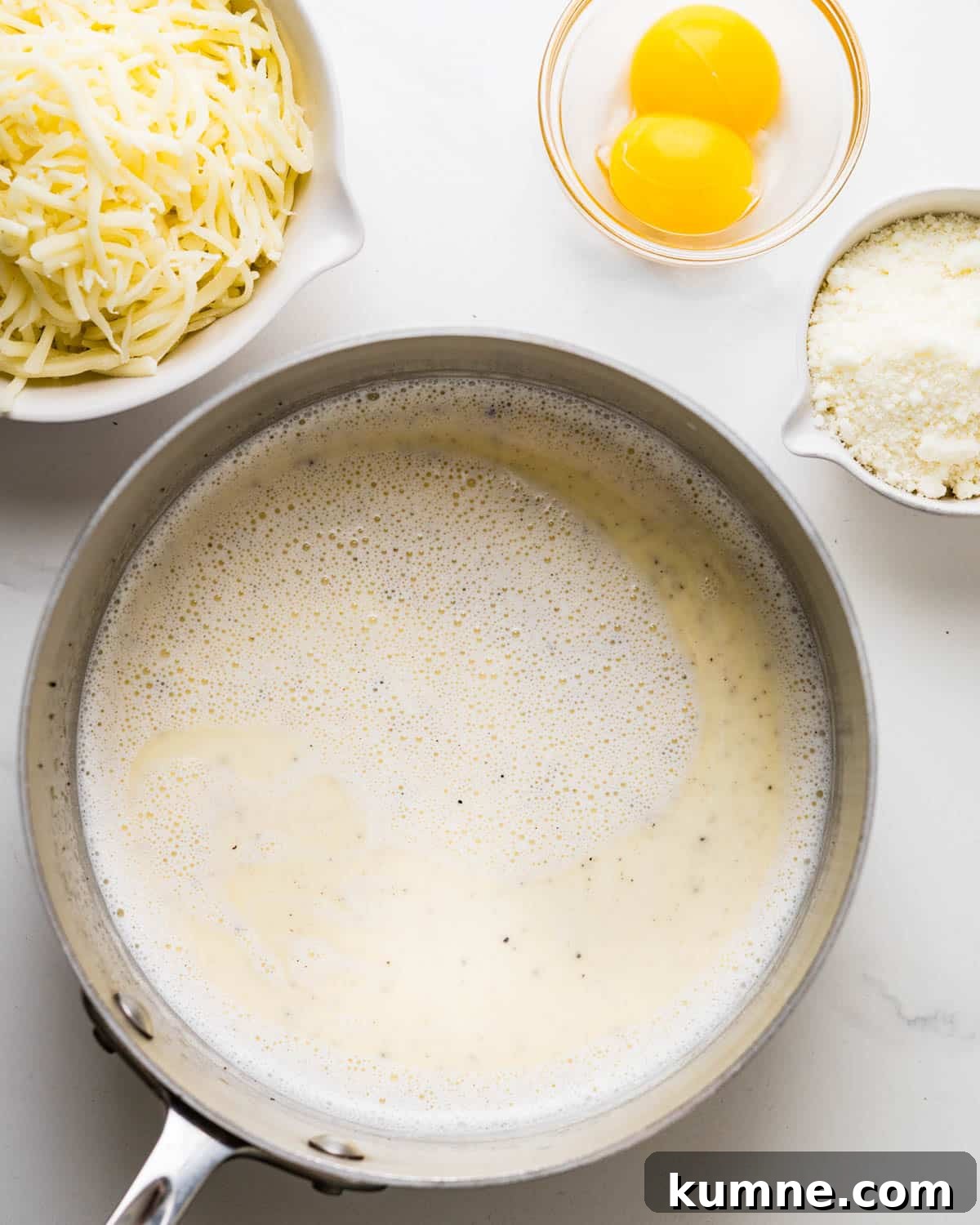 Creamy Chicken Alfredo Stuffed Shells Recipe for Dinner 5 Heating milk, cream, garlic, salt, and pepper in a saucepan until hot.
