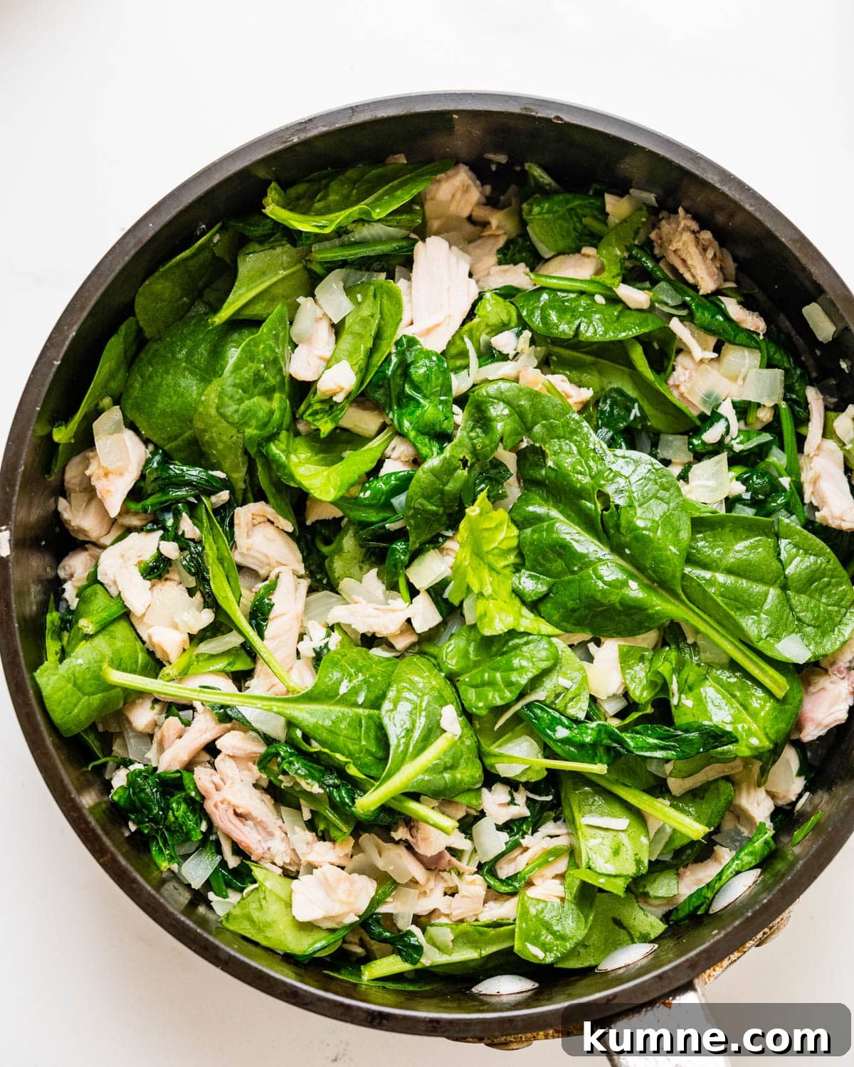 Creamy Chicken Alfredo Stuffed Shells Recipe for Dinner 10 Sauteing the chicken and spinach filling in a saute pan.