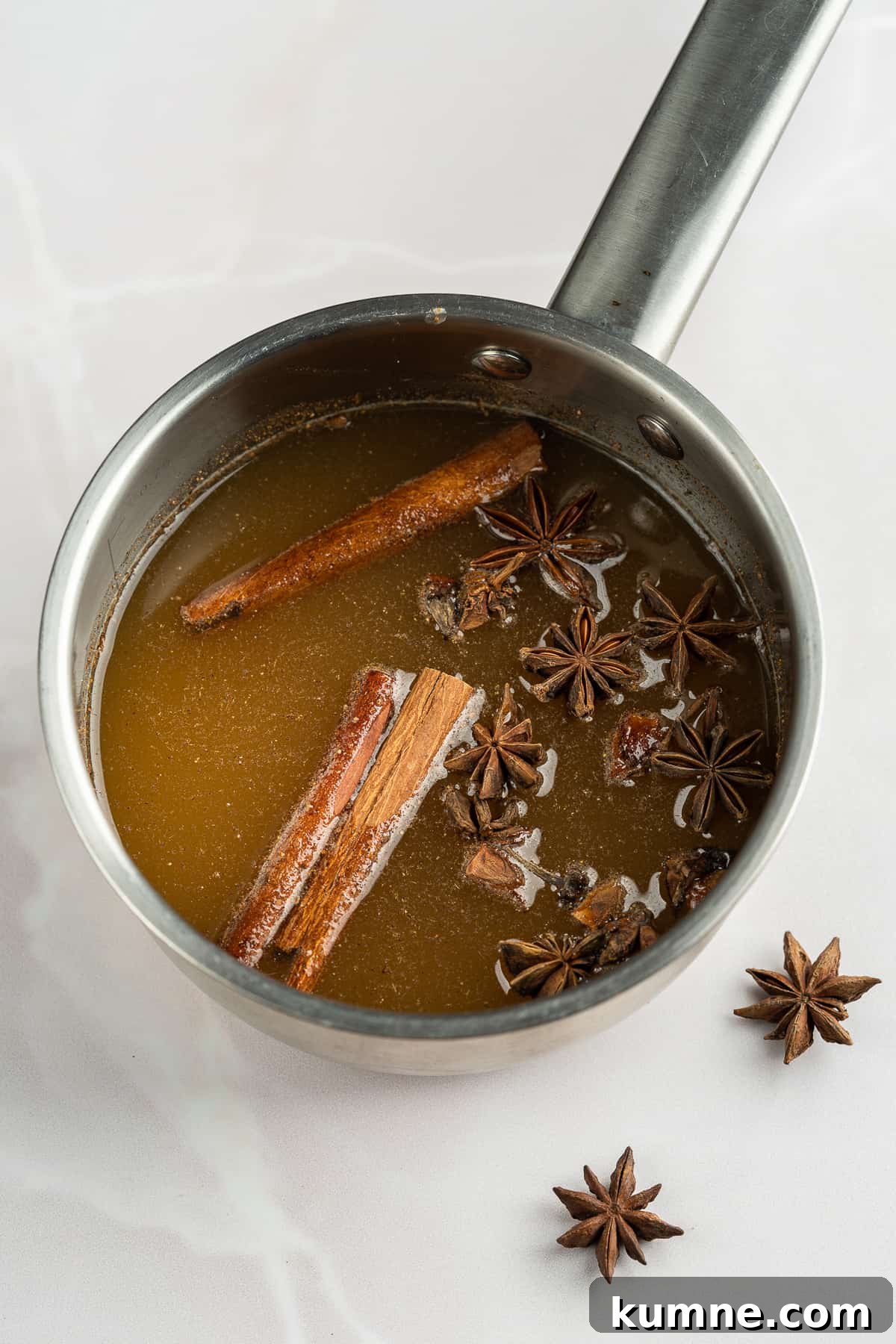 Spiced honey mixture in a saucepan .