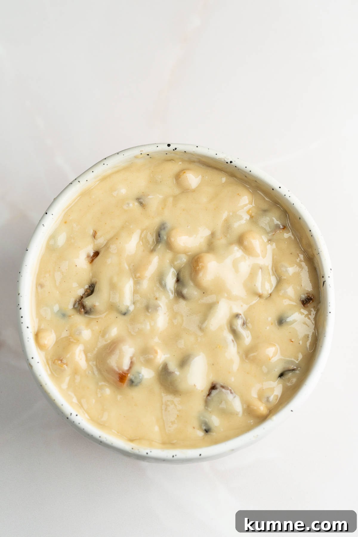 Batter with dried fruit in a bowl .