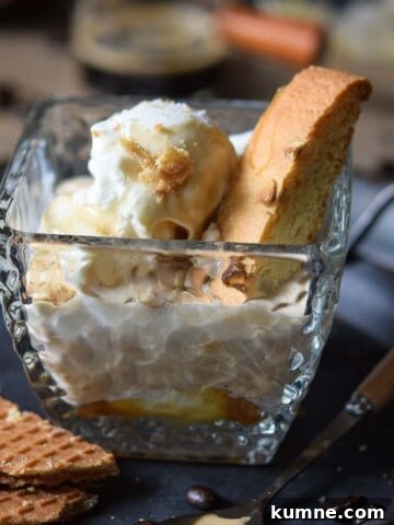Close-up of salted caramel affogato in a clear glass on a grey tray.