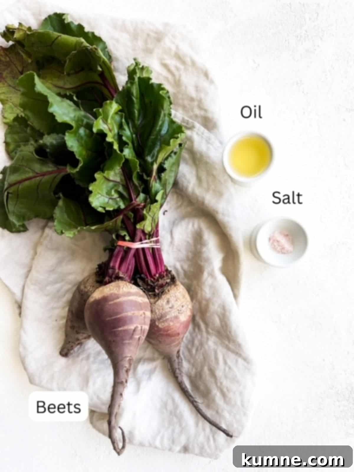 One bunch of beets on a linen napkin, oil, and salt.