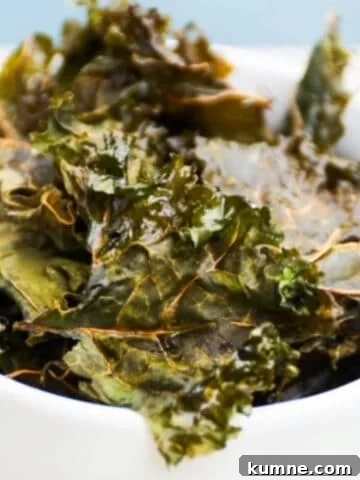 Homemade kale chips in a white bowl.