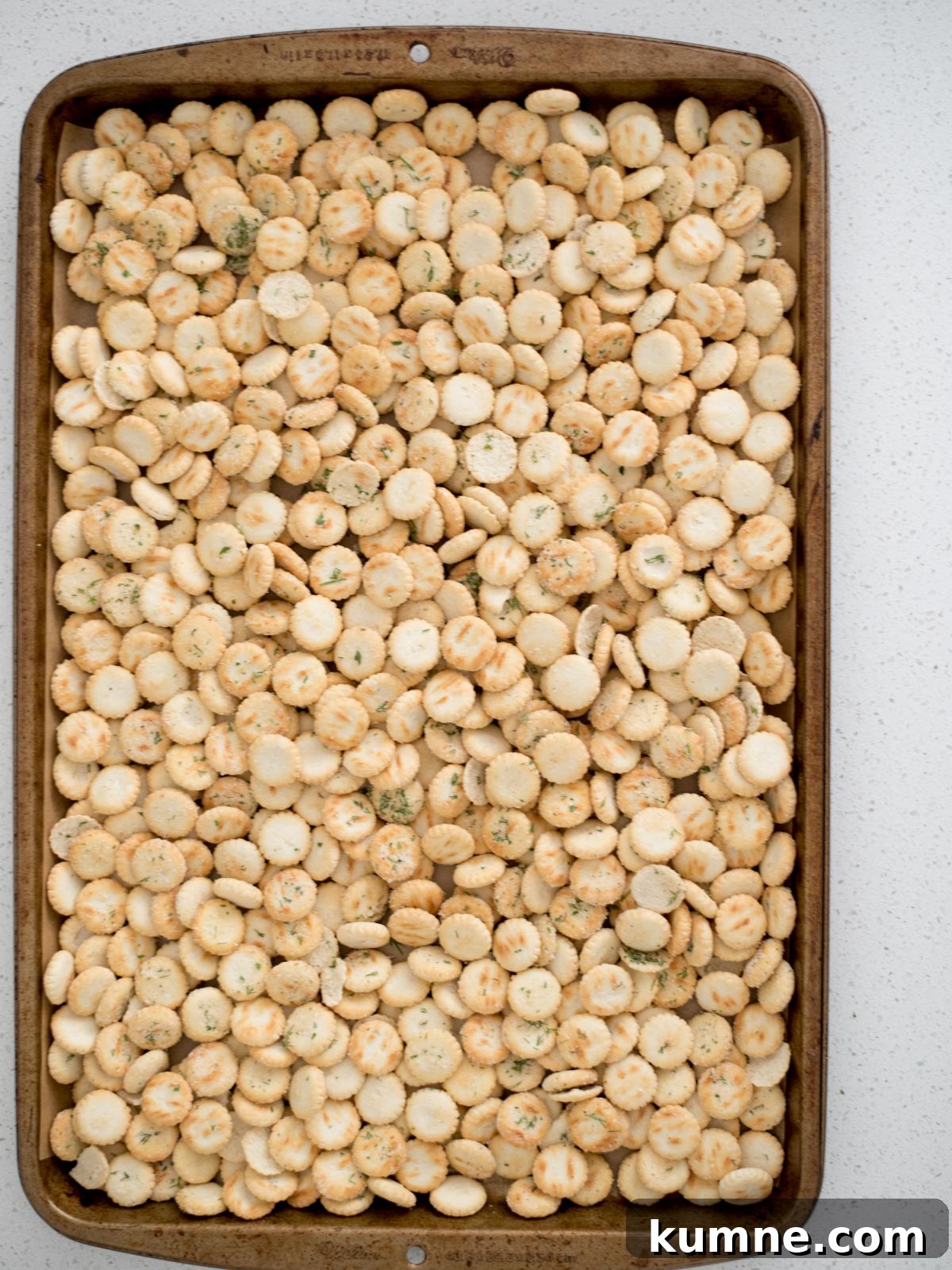 Ranch Dill Oyster Crackers Recipe for Party Snacks 8 Baking sheet with seasoned oyster crackers on top.