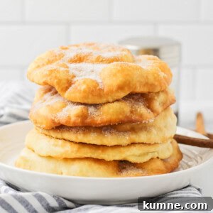 Stack of buñuelos on a plate.