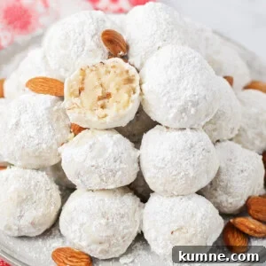 Mexican wedding cookies stacked on plate.