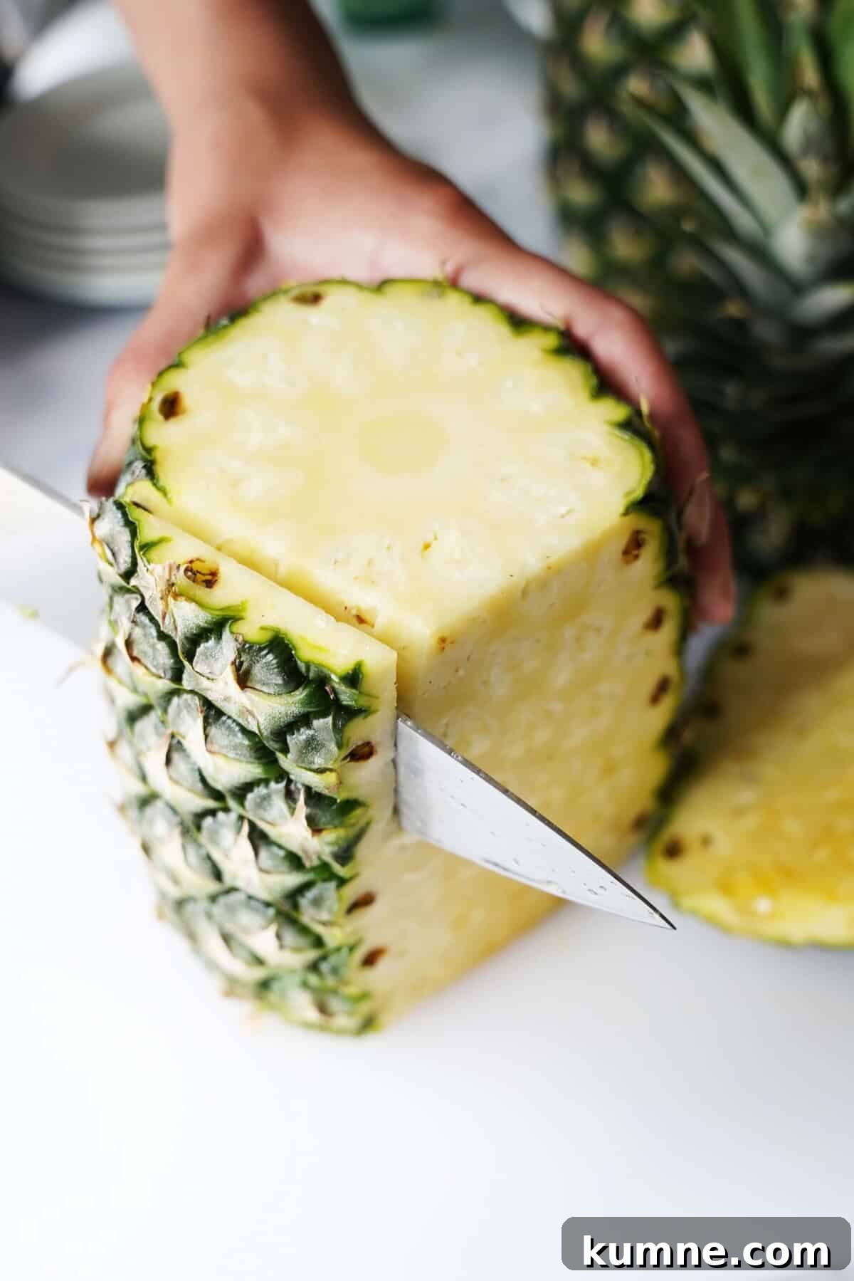 How to Tell When a Pineapple Is Ripe: 7 Signs to Look For 8 Knife running down the side of a pineapple