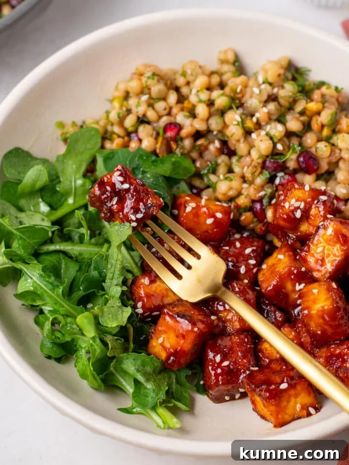 Apricot Harissa Tofu with Couscous Pilaf — Sweet and Spicy Flavor 2 sweet and spicy apricot harissa tofu with couscous pilaf and greens in a dinner bowl