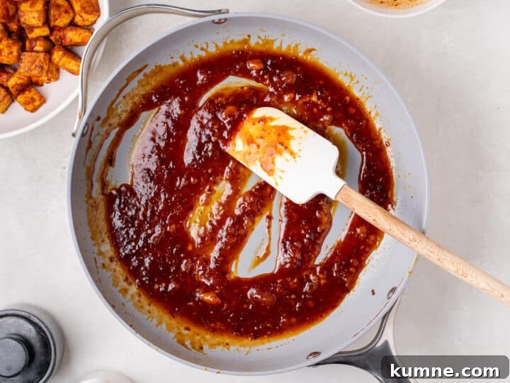Apricot Harissa Tofu with Couscous Pilaf — Sweet and Spicy Flavor 14 apricot sauce simmering in a skillet until thick and glossy