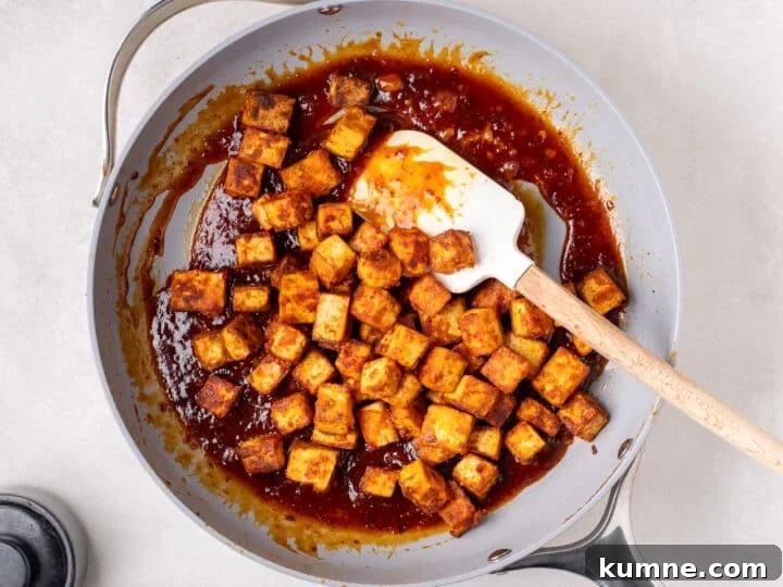 Apricot Harissa Tofu with Couscous Pilaf — Sweet and Spicy Flavor 15 crispy tofu cubes tossed in sticky apricot harissa sauce in a skillet