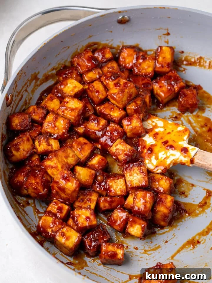 Apricot Harissa Tofu with Couscous Pilaf — Sweet and Spicy Flavor 16 crispy tofu cubes coated in apricot harissa sauce in a skillet