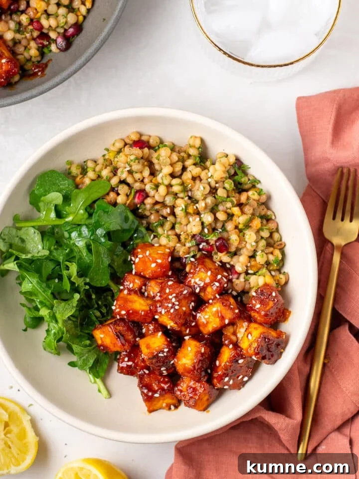 Apricot Harissa Tofu with Couscous Pilaf — Sweet and Spicy Flavor 17 bowl of crispy apricot harissa tofu served with herby couscous pilaf and fresh arugula
