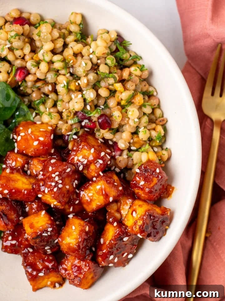 Apricot Harissa Tofu with Couscous Pilaf — Sweet and Spicy Flavor 19 close-up of crispy harissa tofu cubes coated in sticky apricot harissa glaze