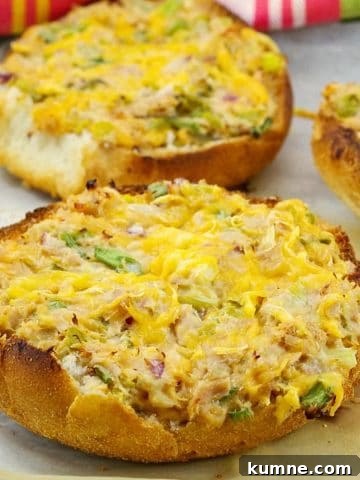 Open faced tuna melts on parchment paper covered baking sheet