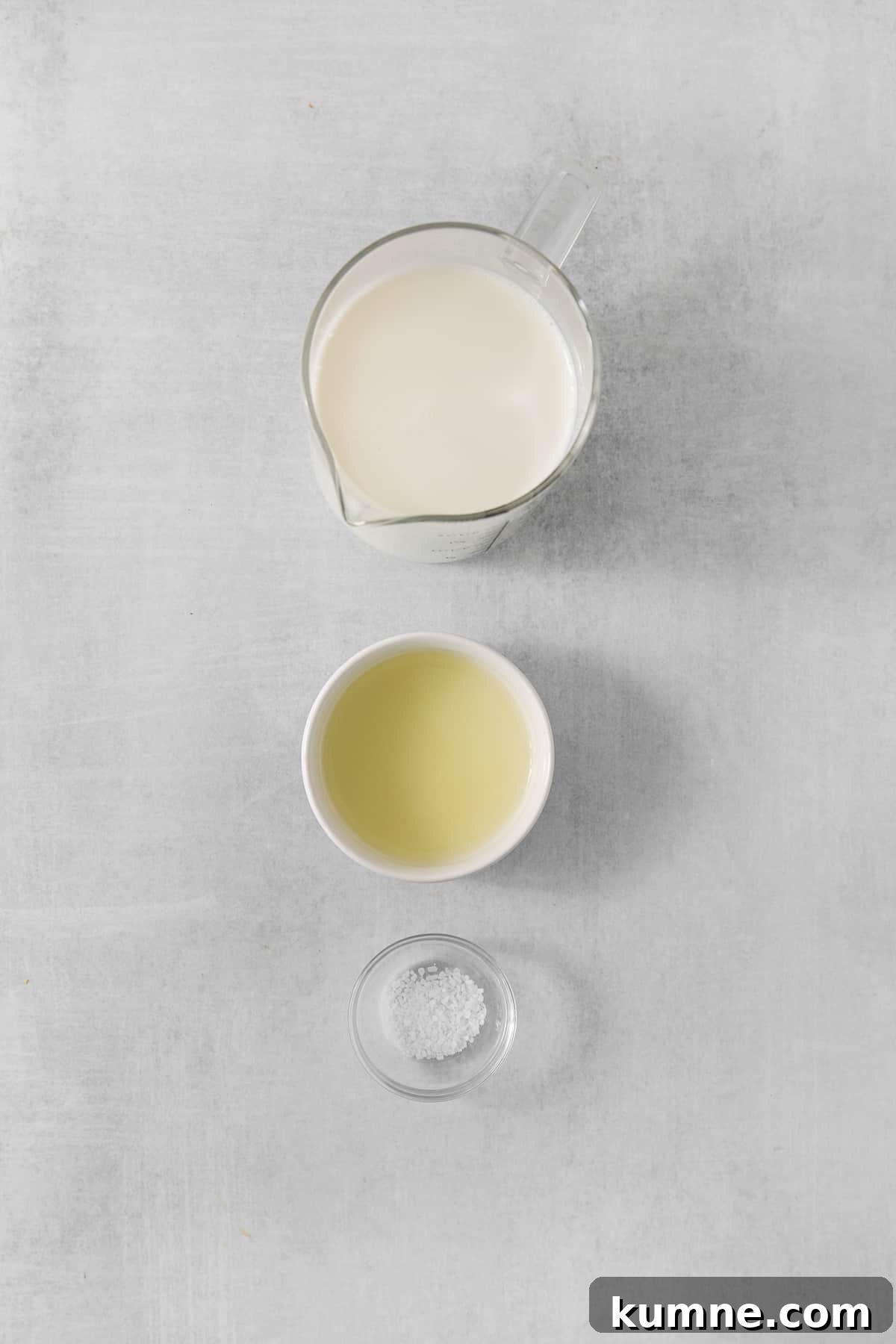 a bowl of milk and a bowl of sugar on a gray background.