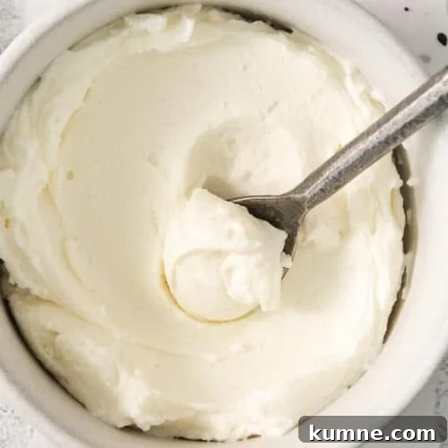 whipped cream in a bowl with a spoon.