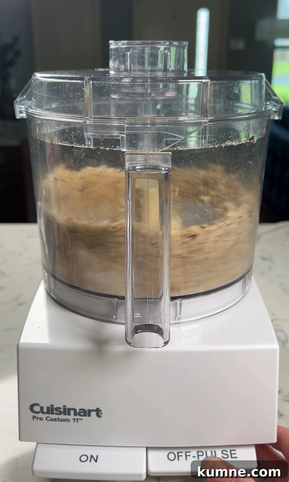 Salted Caramel Hazelnut Fastelavnsboller Recipe 11 Adding hazelnuts to a food processor to finely mill them.