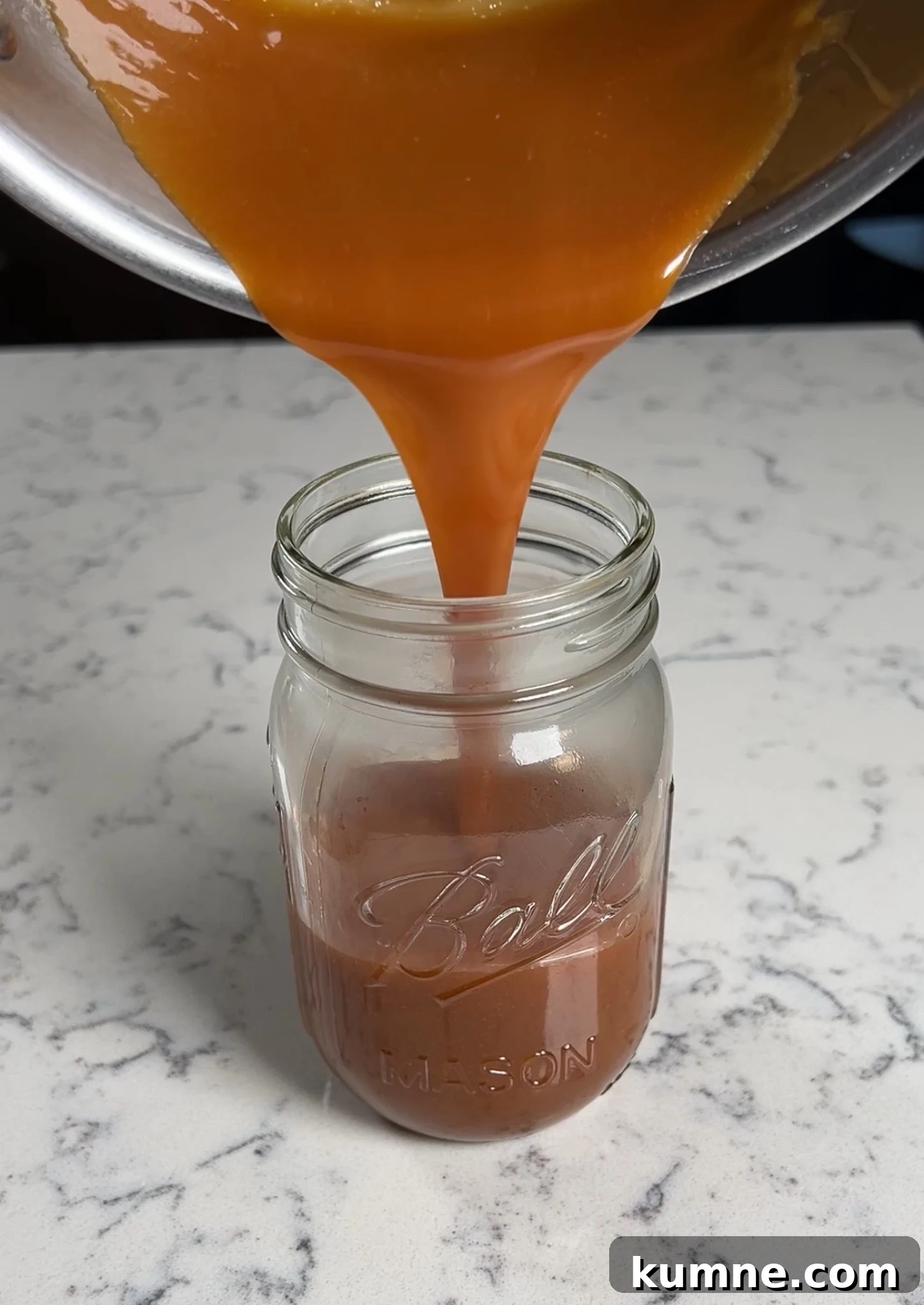 Salted Caramel Hazelnut Fastelavnsboller Recipe 16 Adding caramel to a jar to cool down.