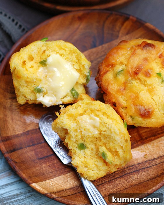 Cheddar Jalapeno Cornbread Muffins with butter on them
