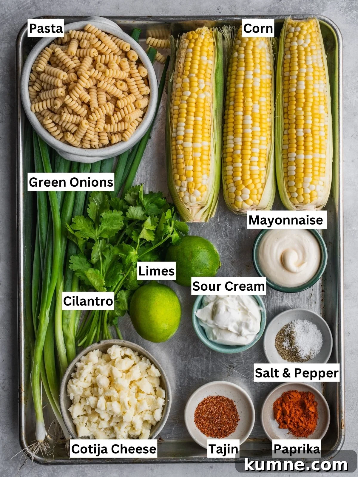 Elote Pasta Salad Inspired by Mexican Street Corn 3 Mexican-inspired elote pasta salad recipe ingredients with individual labels laid out in a tray.