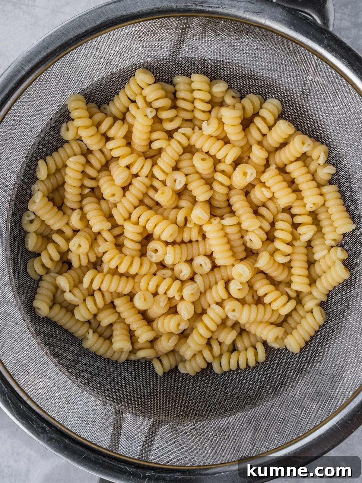 Elote Pasta Salad Inspired by Mexican Street Corn 4 Cooked pasta is draining in a colander.