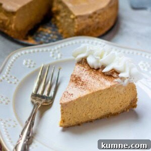 Instant Pot Pumpkin Cheesecake Recipe: Creamy Spiced Dessert 2 Slice of Instant Pot Pumpkin Cheesecake on plate with fork with remaining pumpkin cheesecake in background.
