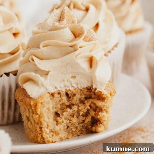 A close up of a coffee cupcake with a bite taken out of it.