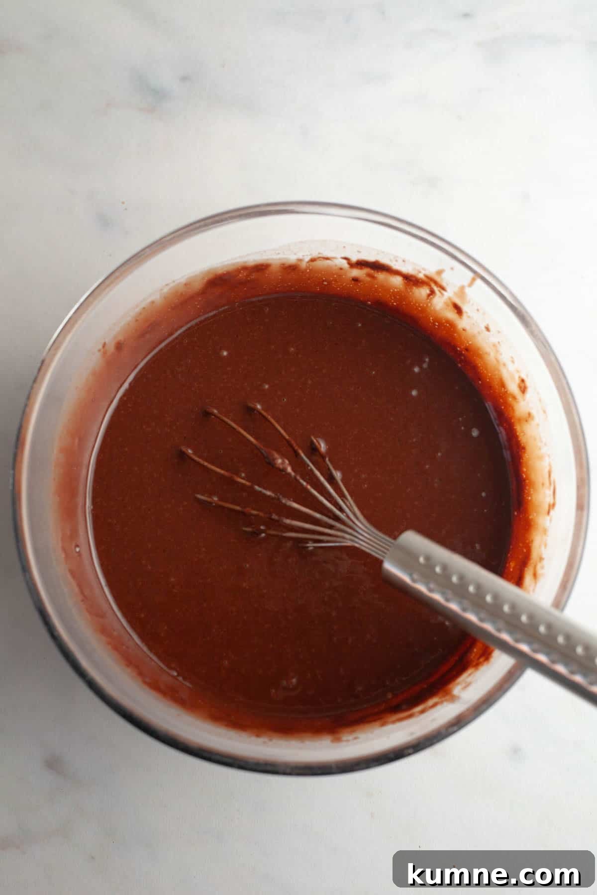 Moist Chocolate Cupcakes with Cream Cheese Frosting Recipe 6 Chocolate cupcake batter in a bowl with a whisk.