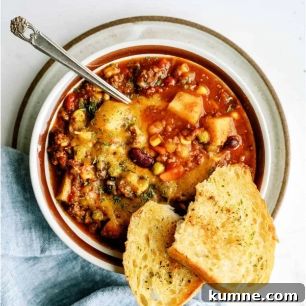10 Make-Ahead Slow Cooker Freezer Meals You Can Prep in 90 Minutes 7 A bowl of shepherd's pie chili topped with herbs, served with a spoon and two slices of toasted bread on the side.
